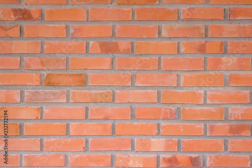 Orange brick wall texture background. Brickwork or stonework flooring interior rock old pattern clean concrete grid uneven bricks design stack.