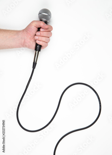 Hand Holding Microphone with Cable Isolated on White Background