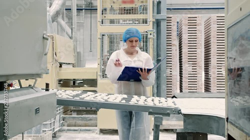 Controller checking conveyor with candies. Candy factory.