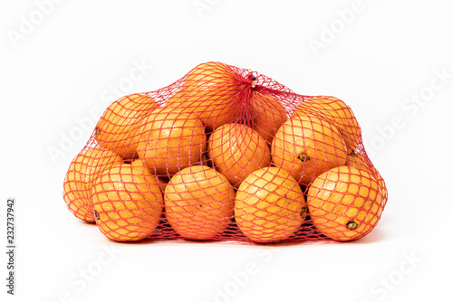 Netted bag of tangerines, isolated on white background.