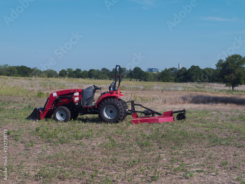 red agriculture equipment on farm 