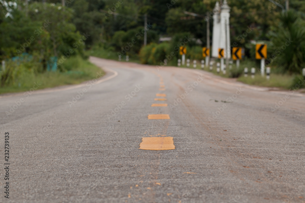 Obraz premium Road Signs warn Drivers for Ahead Dangerous Curve