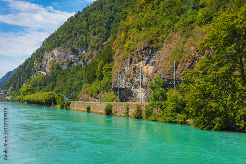 The Aare river flowing along the slope of Mt. Harder in the city of Interlaken, Switzerland