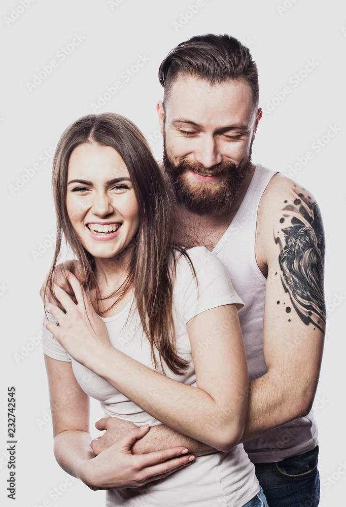 Happy couple embracing and looking camera on white background Happy couple embracing and looking camera on white background