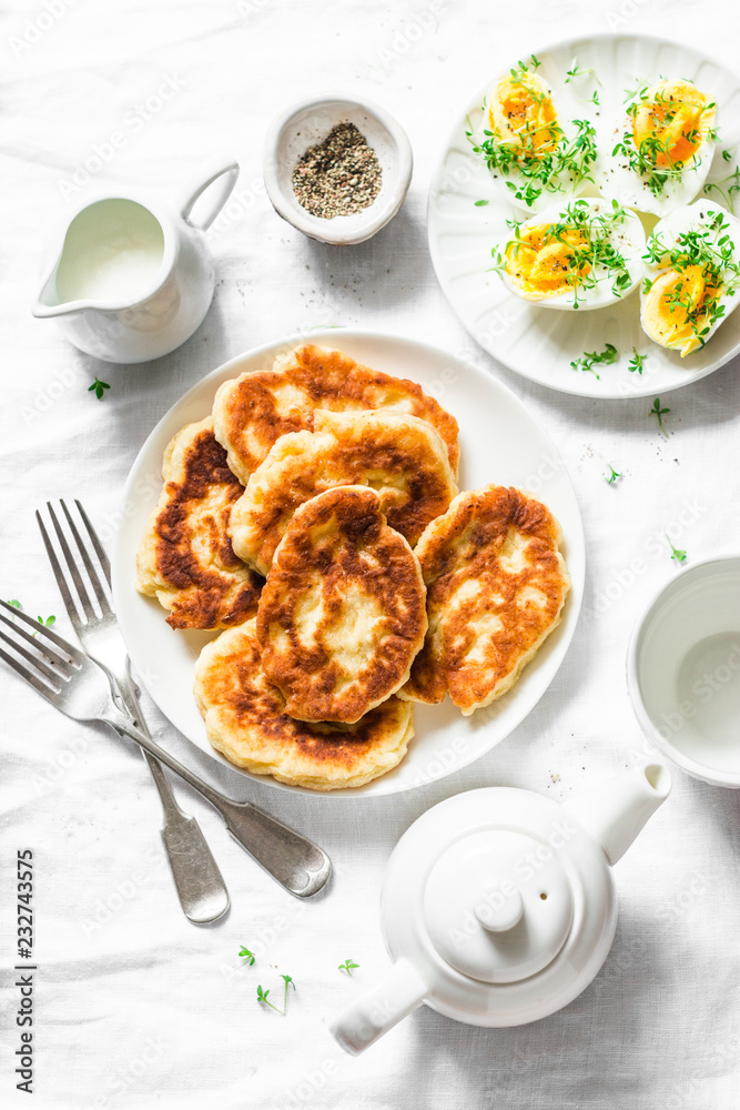 Served breakfast table - potato scones and boiled eggs on a light background, top view. Delicious brunch, snack, appetizer Served breakfast table - potato scones and boiled eggs on a light background, top view. Delicious brunch, snack, appetizer