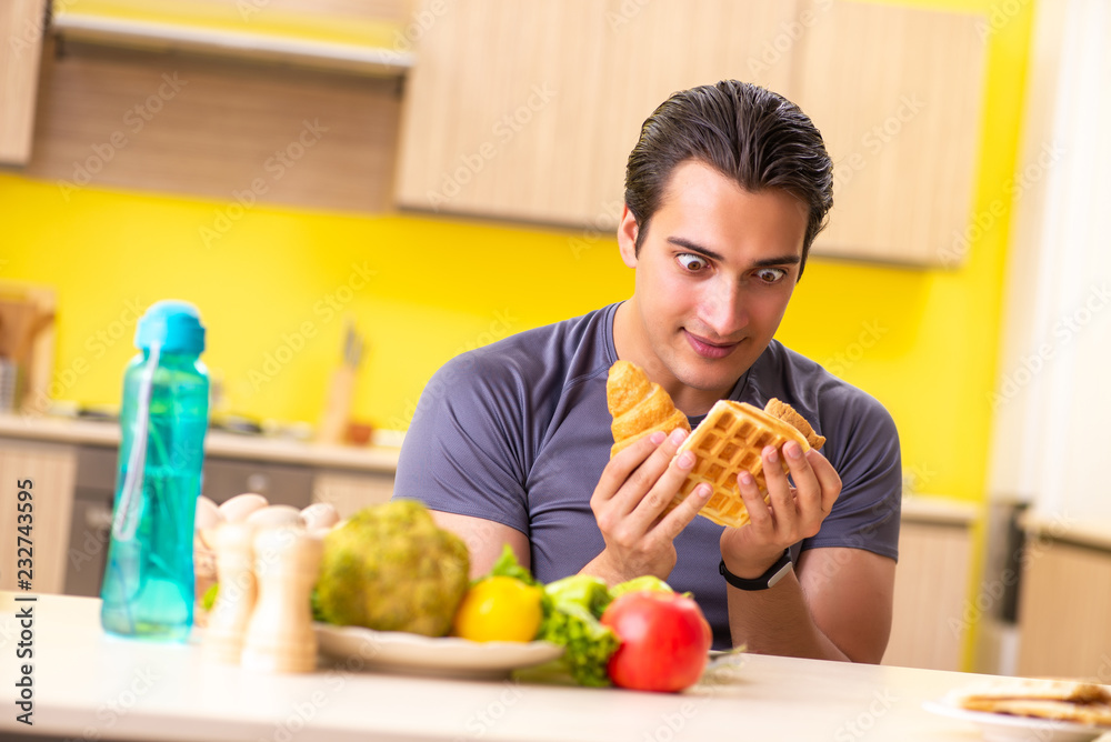 Man having hard choice between healthy and unhealthy food Man having hard choice between healthy and unhealthy food