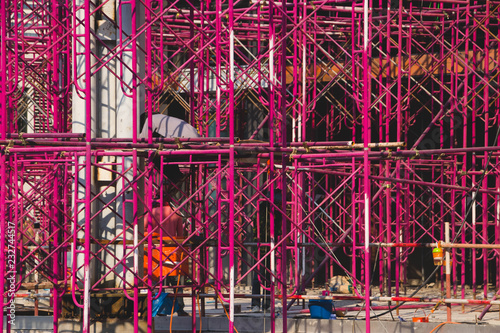 In the construction site. Steel red structure is under construction.