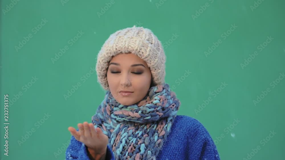 Tender woman having fun in the snow weather. Snow falling on the girl. Snowflakes in super slow motion 1080p hd footage. Christmas, New Year winter holidays concept. Attractive girl standing against