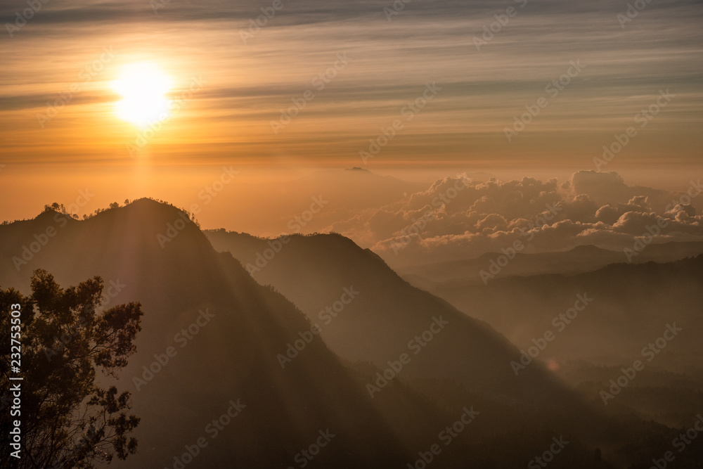 Sunrise over mountain with fog with village on hill Sunrise over mountain with fog with village on hill