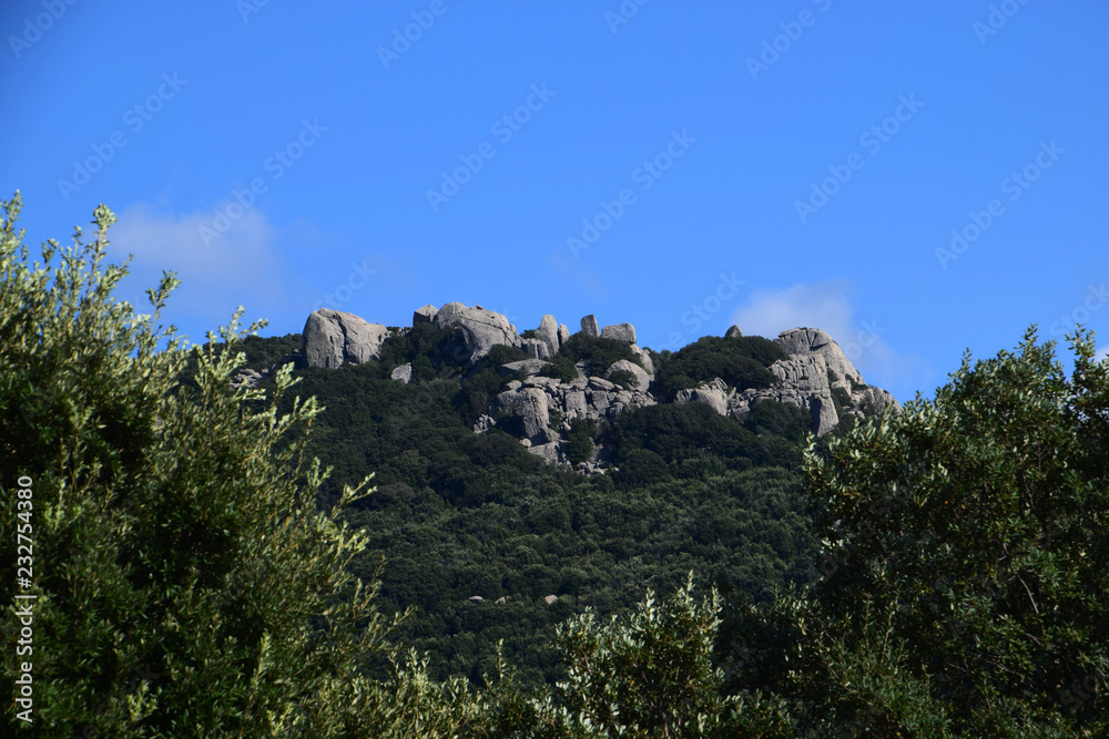 granite rocks formation with azure sky in sardinia, rocky granitic massif landscape impressions in north sardinia in autumn as a rock background