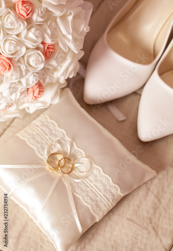 Wedding detail - shoes, rings and flowers on soft background
