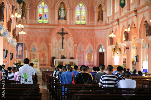 Chantaburi, Thailand - July 30, 2018: Selective focus of Group of pastors doing religion ceremony , Christian people attend praying in a beautiful church name" Wat Mae Pra Patisonti Narumol"