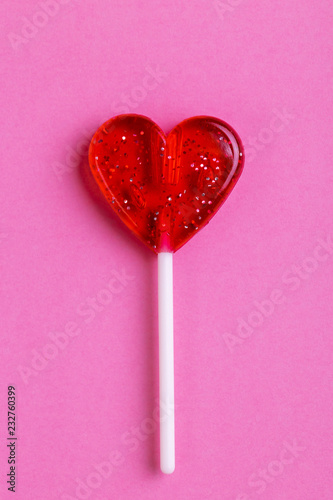 Red sweet tasty lollipop in shape of heart