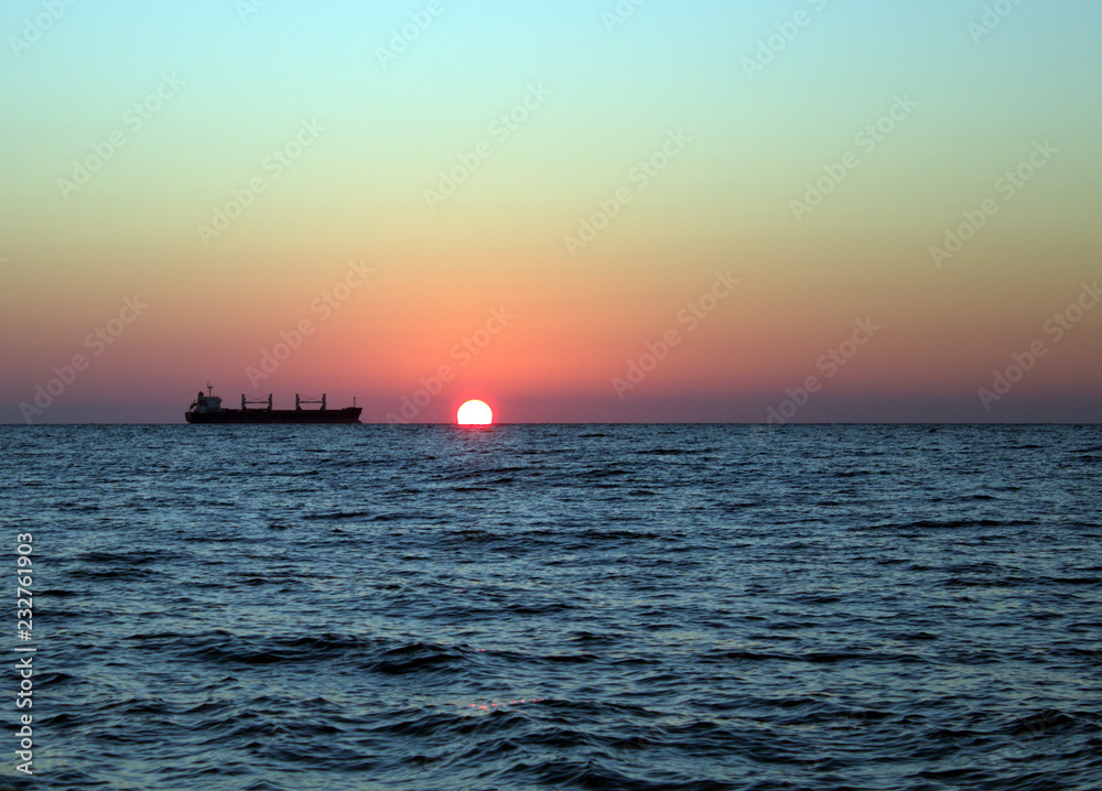 Cargo ship at sunset in the Black sea