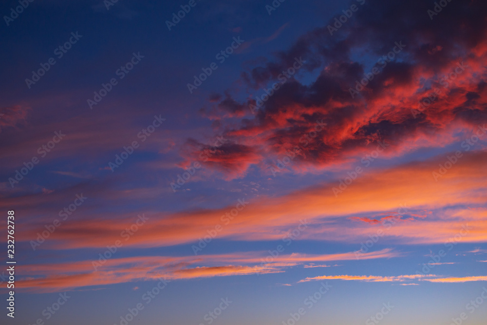 dramatic blue sky with orange clouds at sunset