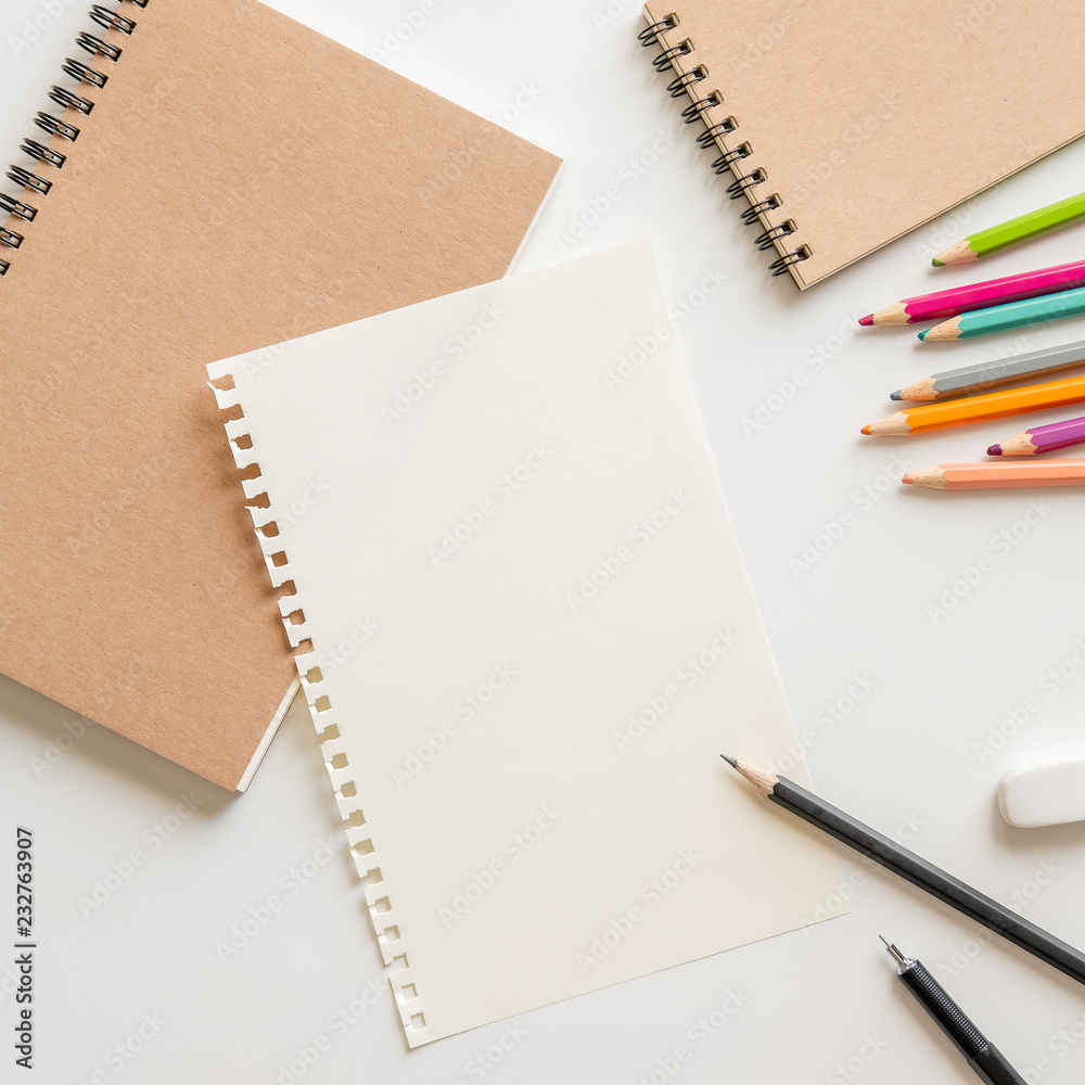 blank paper with spiral notebook, pencil, eraser and color pencil on white background. Empty Space for your Text. blank paper with spiral notebook, pencil, eraser and color pencil on white background. Empty Space for your Text.