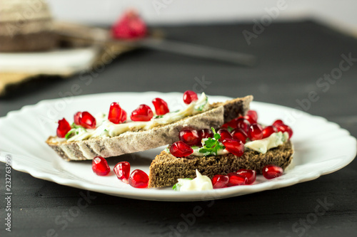 sandwich with cheese, greens and pomegranate berries
