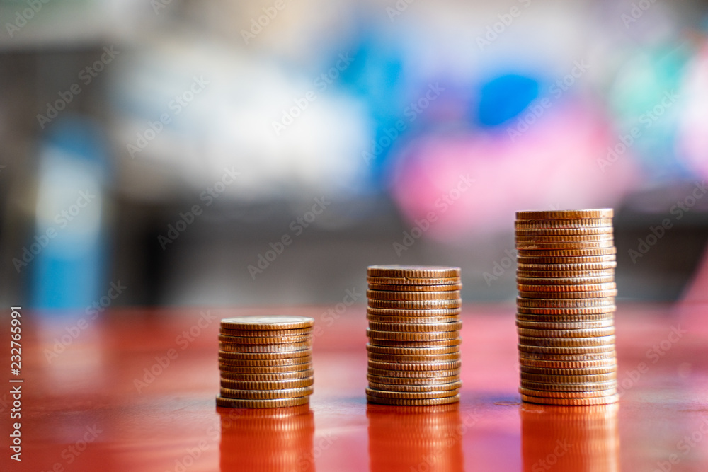 step of coins stacks with sandglass.or hourglass, saving and investment or family planning concept, motion blured background. step of coins stacks with sandglass.or hourglass, saving and investment or family planning concept, motion blured background.
