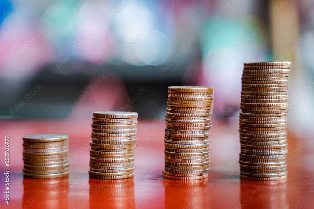 step of coins stacks with sandglass or hourglass, saving and investment or family planning concept, motion blured background. step of coins stacks with sandglass or hourglass, saving and investment or family planning concept, motion blured background.