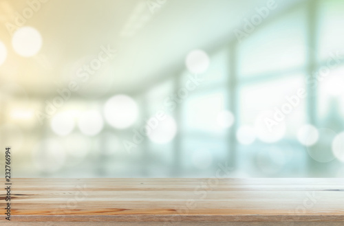 Wooden desk with Blurred of interior office room with city building background