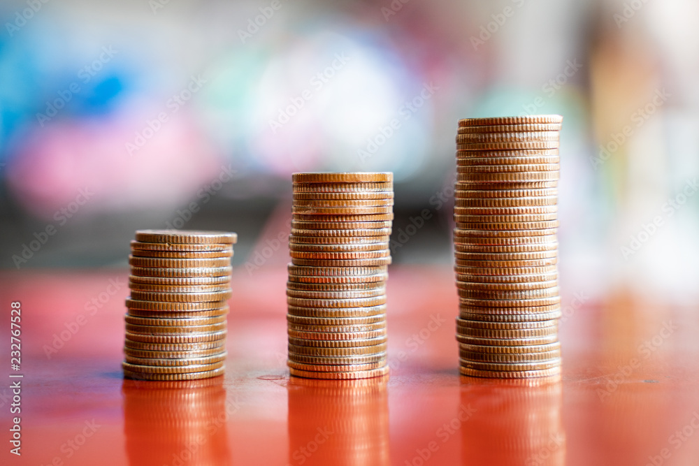 step of coins stacks, saving and investment or family planning concept, motion blured background. step of coins stacks, saving and investment or family planning concept, motion blured background.