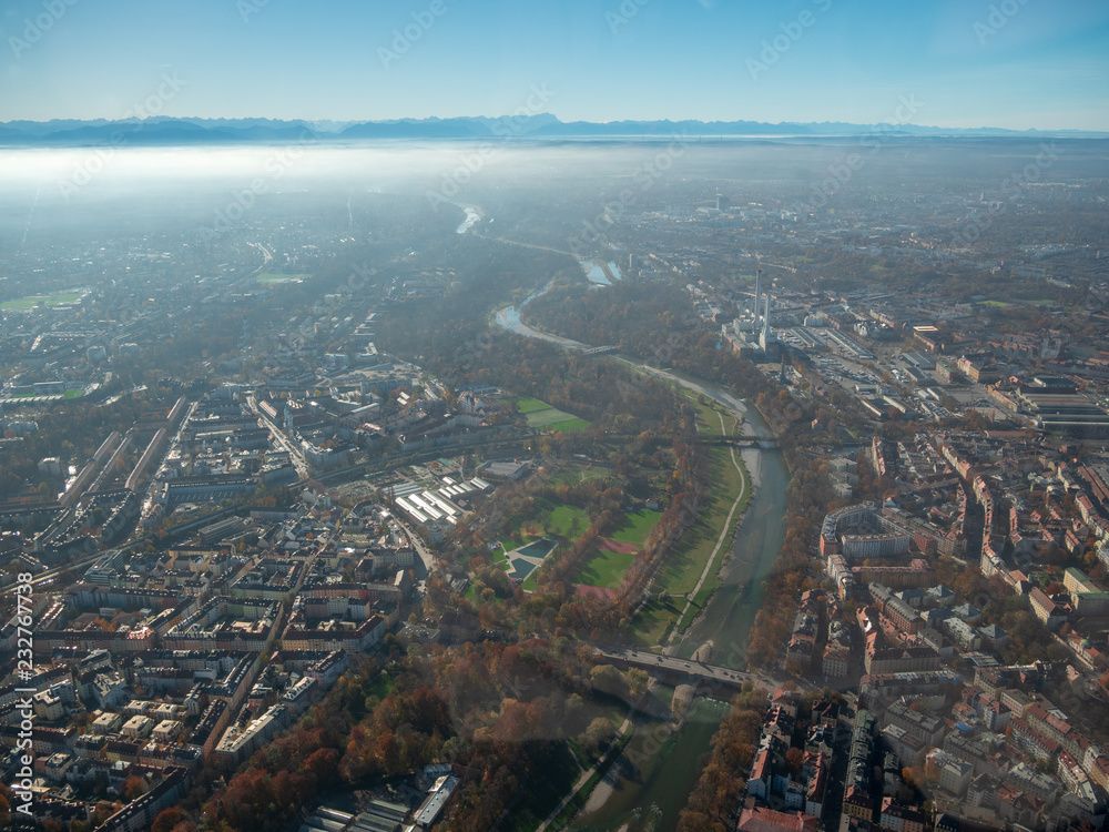 Helicopter view towards the munich and the alps toughed with fog