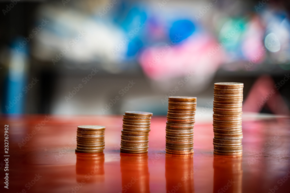 step of coins stacks, saving and investment or family planning concept, motion blured background. step of coins stacks, saving and investment or family planning concept, motion blured background.