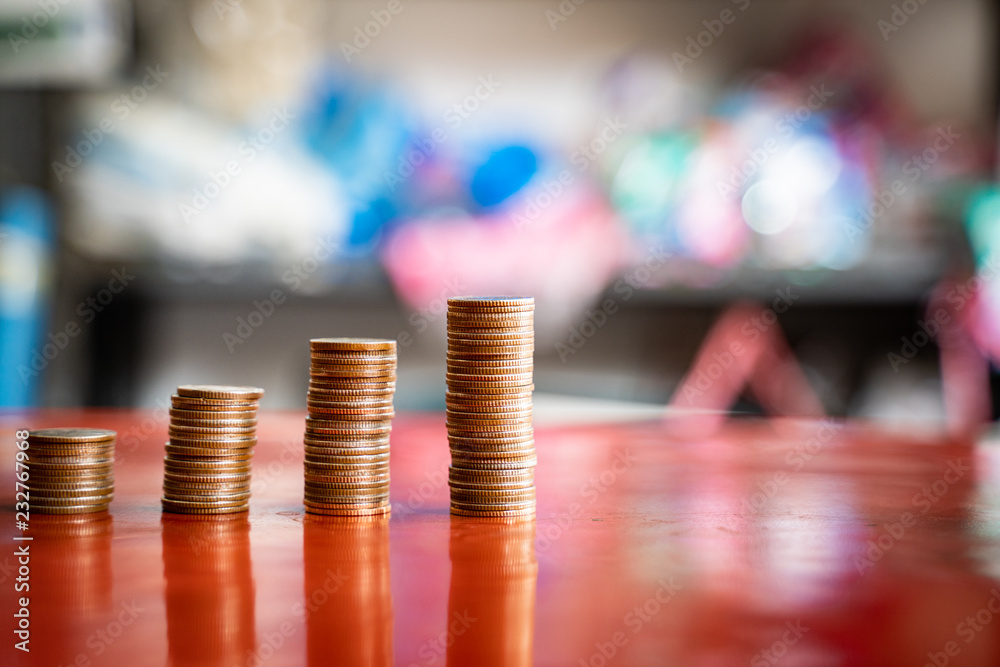 step of coins stacks, saving and investment or family planning concept, motion blured background.