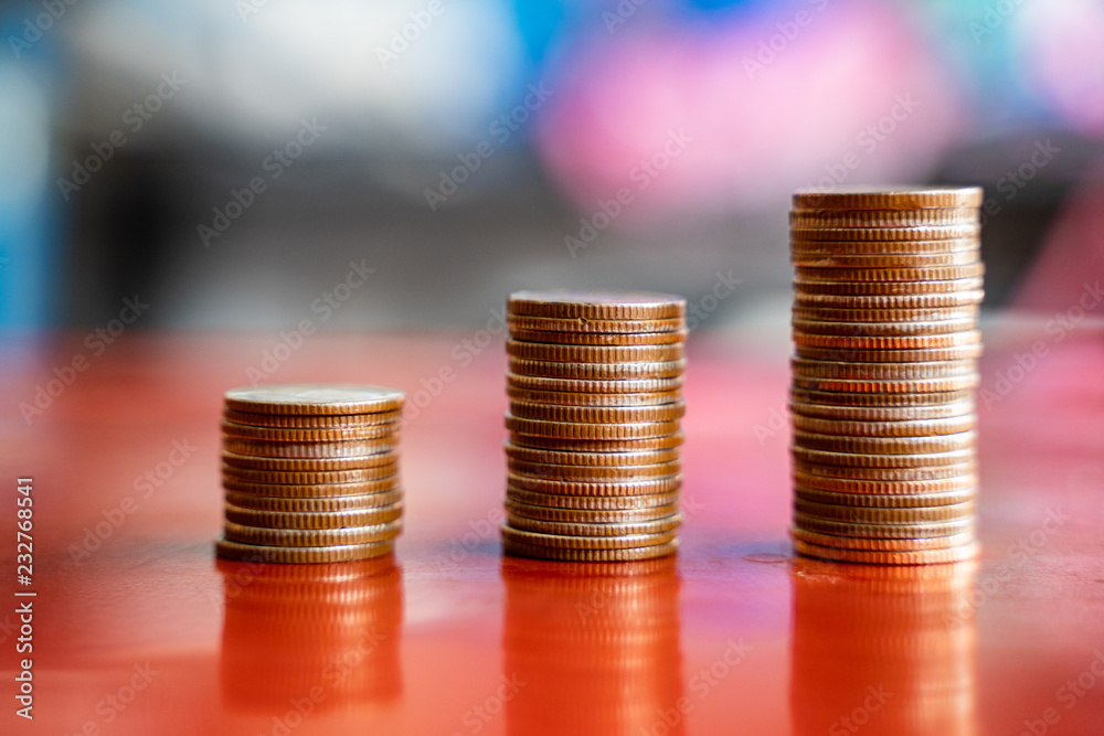 step of coins stacks, saving and investment or family planning concept, motion blured background. step of coins stacks, saving and investment or family planning concept, motion blured background.