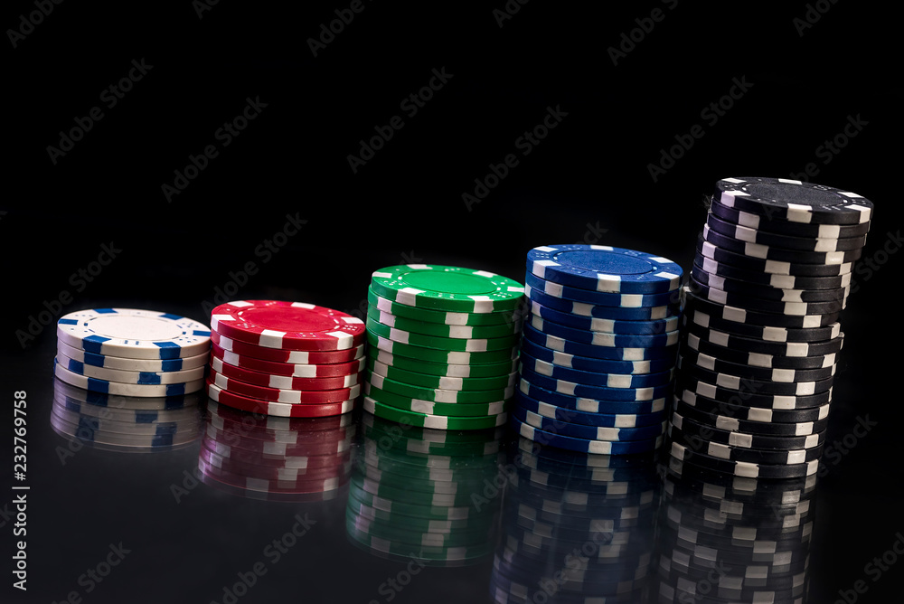 Casino chips in heaps on black table