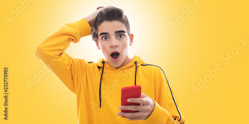 young teenager with mobile phone and isolated expression