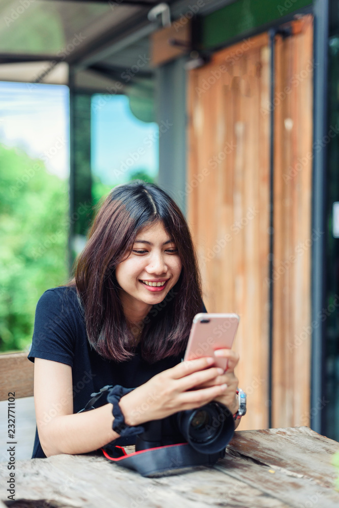 Beautiful and Happy Asian Woman holding Camera in the Garden. Beautiful and Happy Asian Woman holding Camera in the Garden.