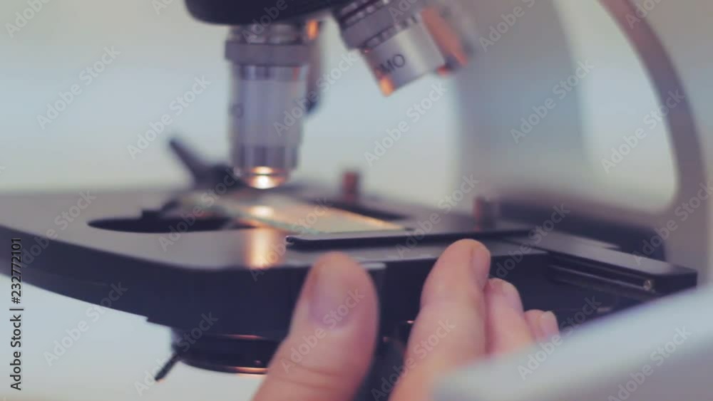 Close up of examining of test sample under the microscope in laboratory. Close up of examining of test sample under the microscope in laboratory.