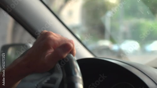 Wallpaper Mural Close up of a man's hand on steering wheel - driving thru the city Torontodigital.ca