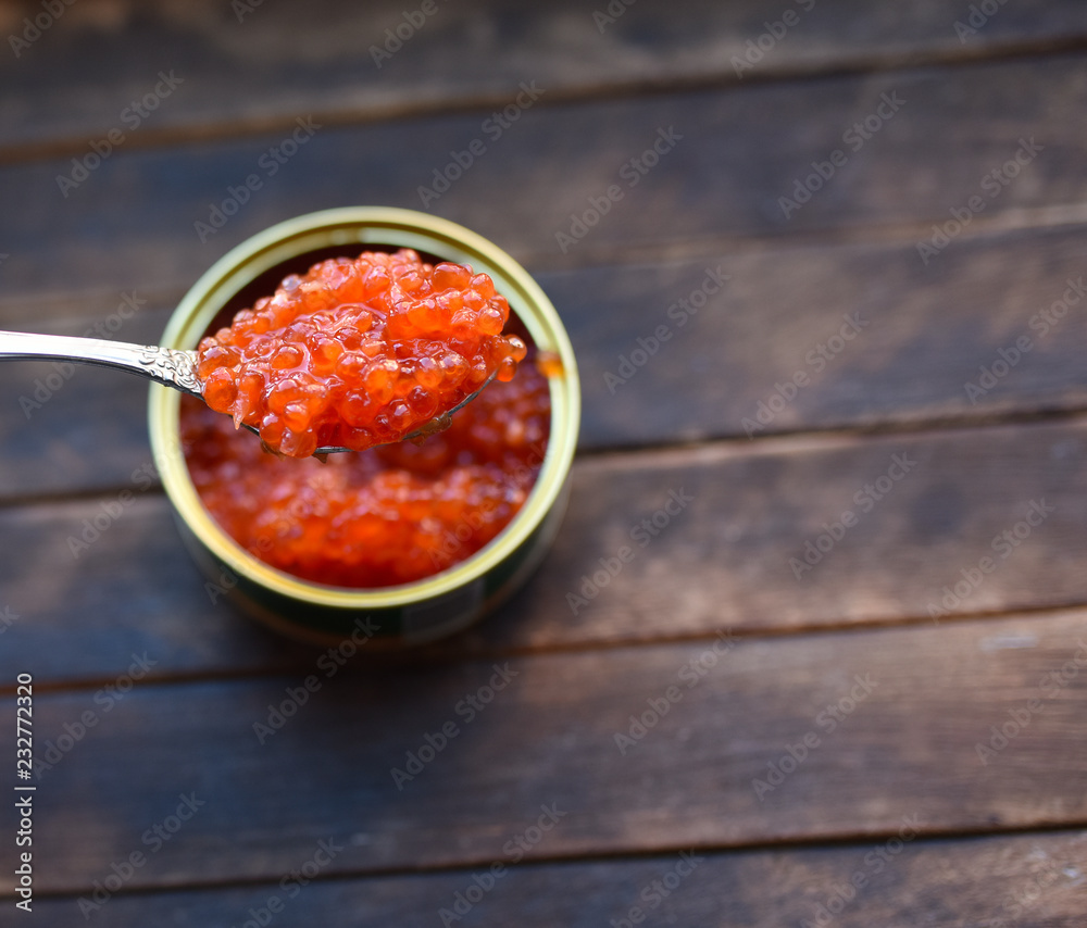 red caviar in a dessert spoon red caviar in a dessert spoon