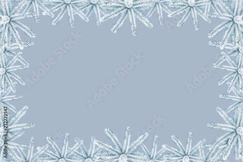Christmas background with snow-covered Gray spruce on canvas with a place for an inscription. Stylish color correction.