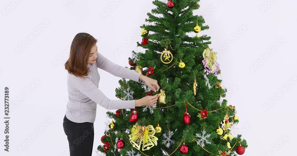 VDO of moving beautiful Asian woman,decorated Christmas tree by golden, red and silver decorations, the white background , Christmas theme. VDO of moving beautiful Asian woman,decorated Christmas tree by golden, red and silver decorations, the white background , Christmas theme.