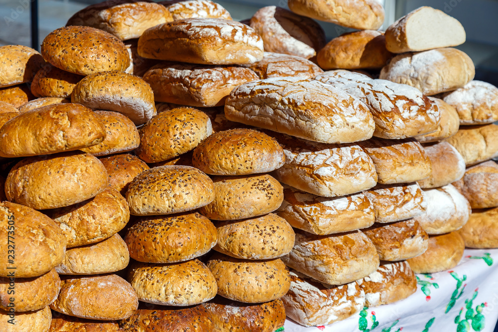 Assortment of different types of breads for sale on the market.