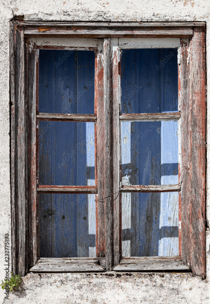 old window of abandoned house in ruins