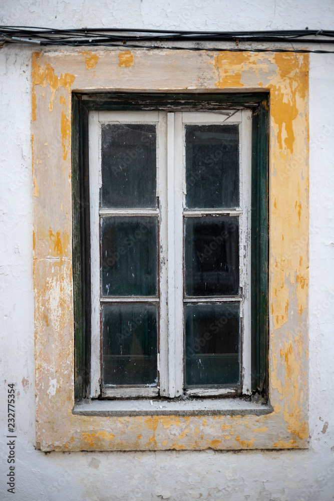 old window of abandoned house in ruins