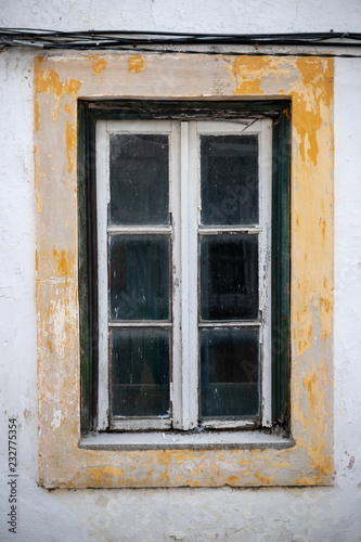 old window of abandoned house in ruins