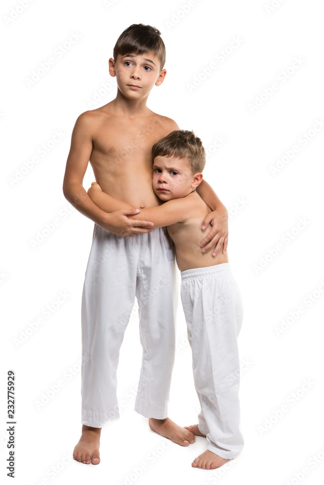 two boys in sportswear for karate, two brothers, elder brother protects the  younger, concept, on a white background, isolate Stock Photo | Adobe Stock