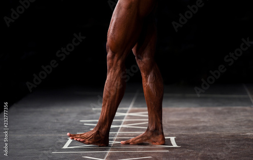 Muscular male legs. Bodybuilding theme
