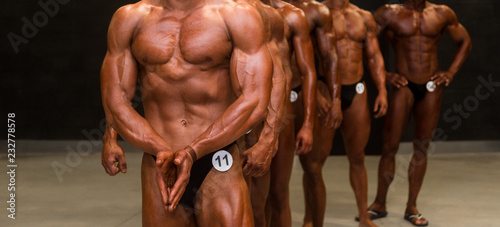 group athletes bodybuilders posing most muscular fitness competitions