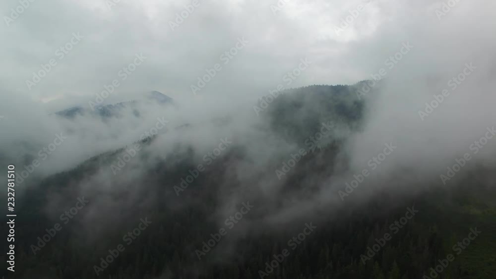 Amazing Aerial View. Flying over the high mountains in beautiful clouds . Aerial camera shot. Air clouds. Fog. Steam. Amazing Aerial View. Flying over the high mountains in beautiful clouds . Aerial camera shot. Air clouds. Fog. Steam.