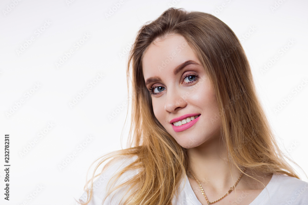 Close-up portrait of beautiful happy young woman with blonde hair and looking at camera on white background Close-up portrait of beautiful happy young woman with blonde hair and looking at camera on white background