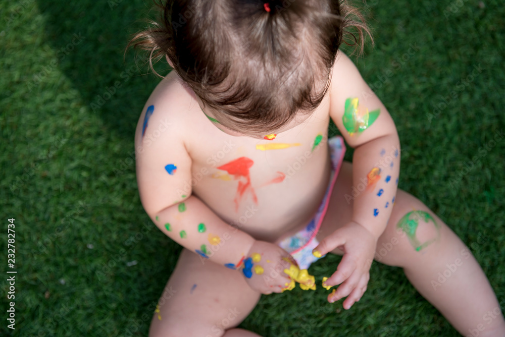 Pretty baby smeared with paints Pretty baby smeared with paints