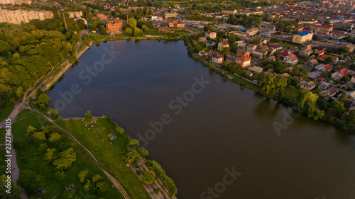 Aerial view of the summer city park near the lake. Beautiful view of nature. © leo_nik