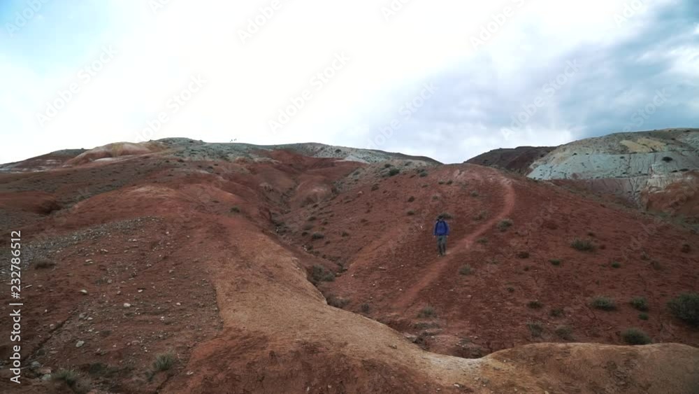 young tourist man descent from the red mountains 50 fps young tourist man descent from the red mountains 50 fps
