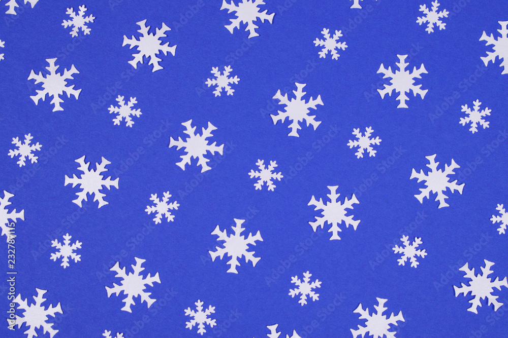 White snowflake confetti on blue background. White snowflake confetti on blue background.